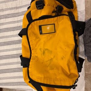 The North Face Yellow Duffel Bag with Black Accents